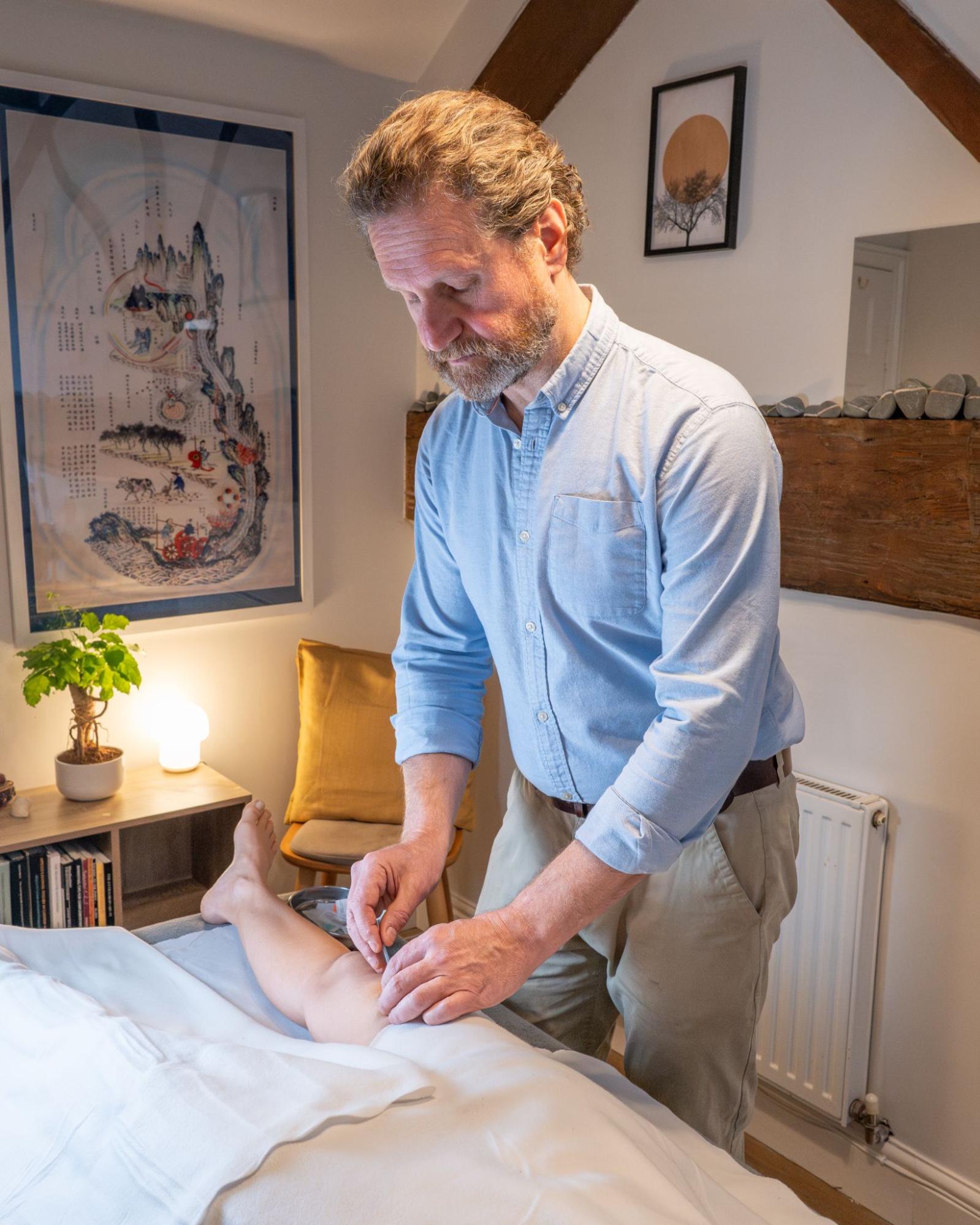 Experienced acupuncturist consulting with patient in Malvern